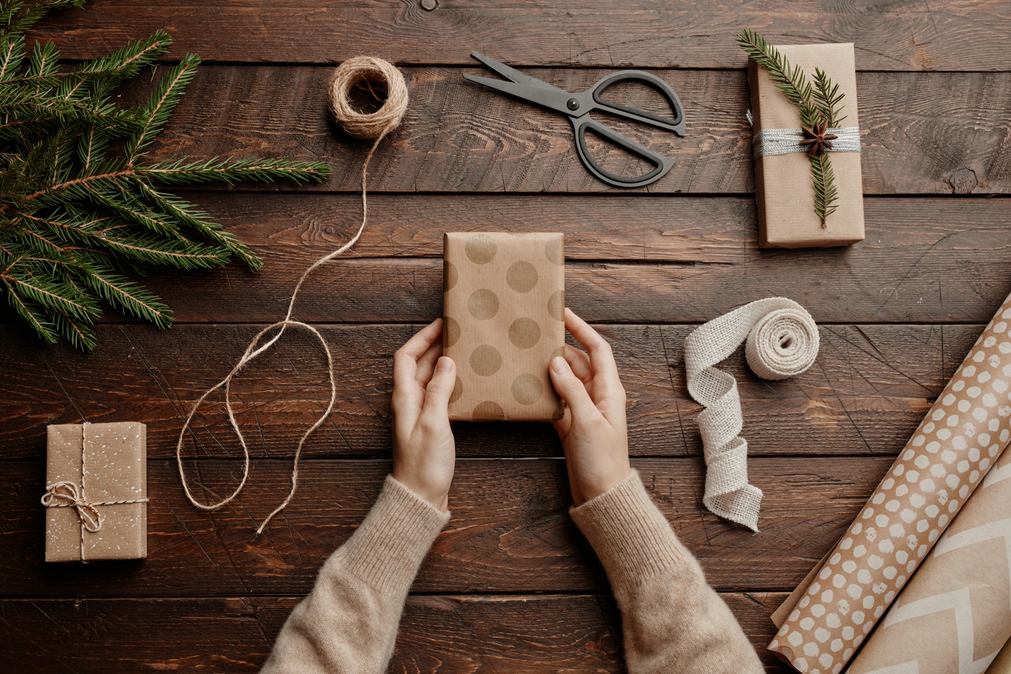 Person wrapping Christmas gifts