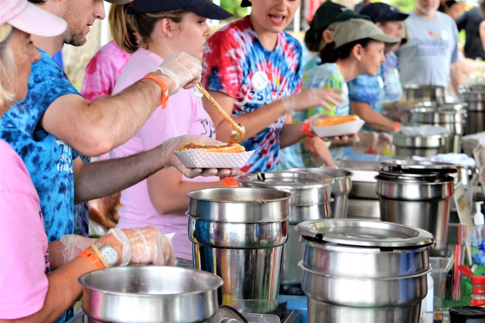 Volunteers cook and serve food to underprivileged people