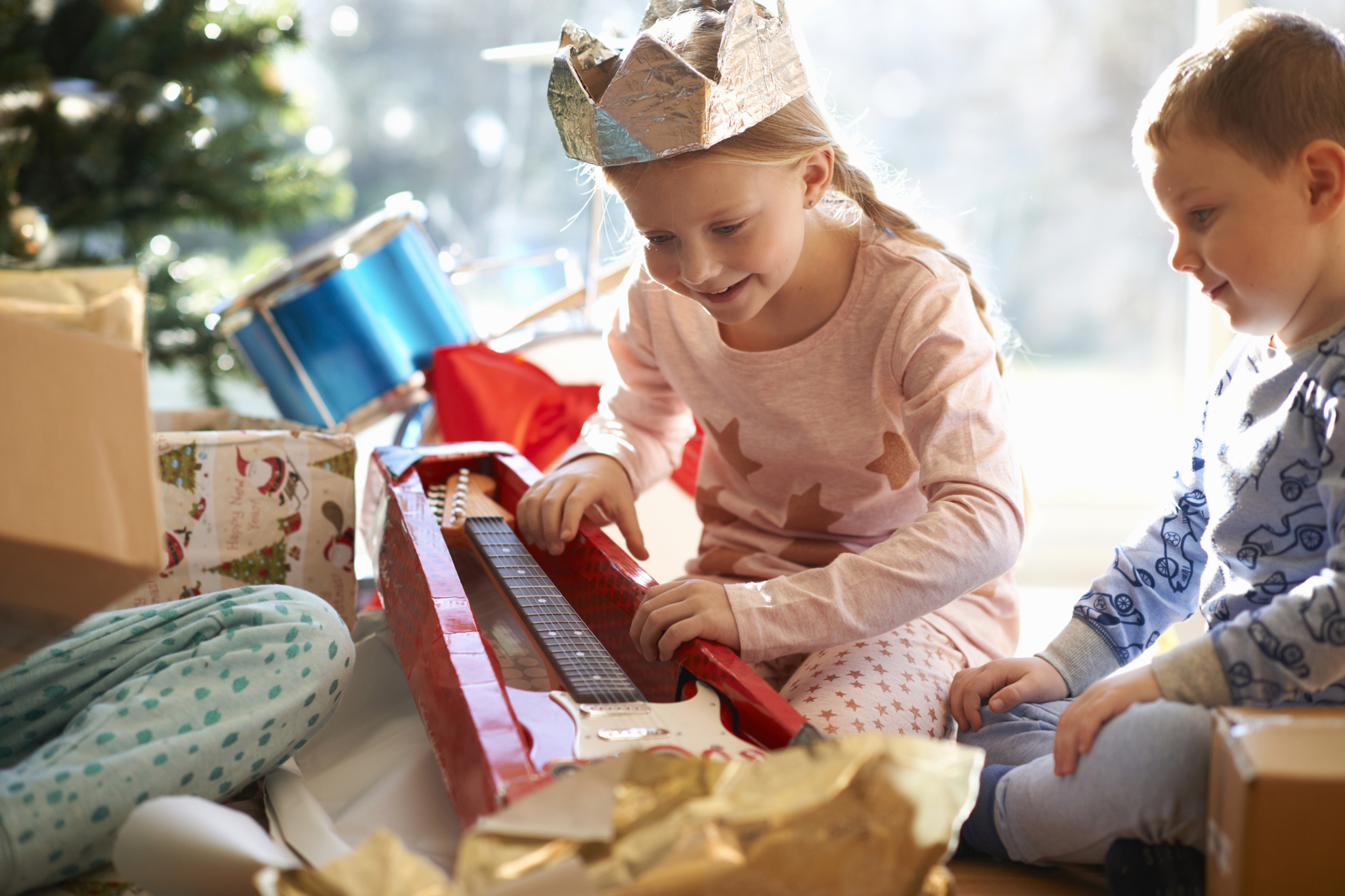 Children unwrapping Christmas gifts